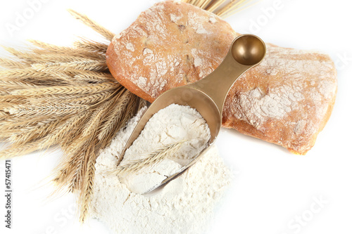 Photo: The wholemeal flour in scoop isolated on white The wholemeal flour in scoop isolated on white