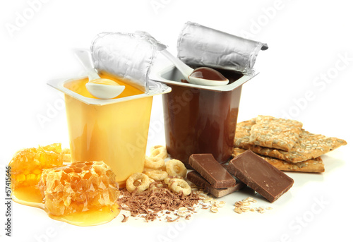 Photo: Tasty desserts in open plastic cups and honey combs, isolated Tasty desserts in open plastic cups and honey combs, isolated