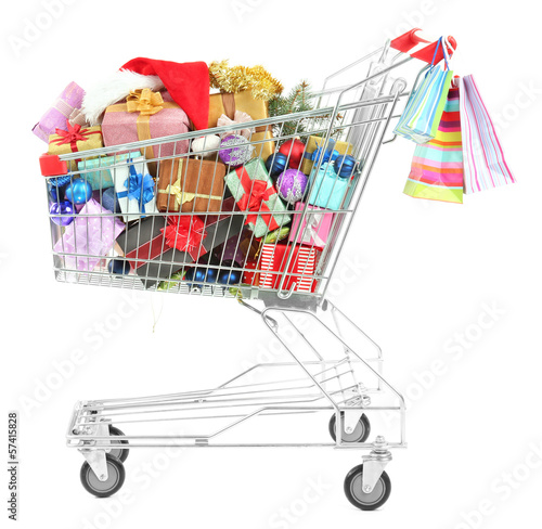 Photo: Christmas gifts in shopping trolley, isolated on white Christmas gifts in shopping trolley, isolated on white