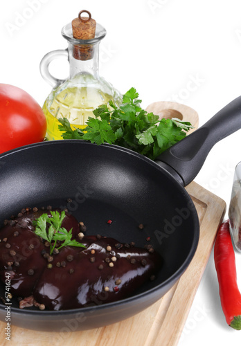 Photo: Raw liver in pan with spices and condiments isolated on white Raw liver in pan with spices and condiments isolated on white