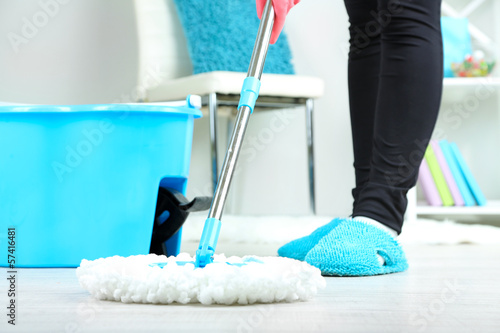 Photo: Mopping floor at home close-up Mopping floor at home close-up