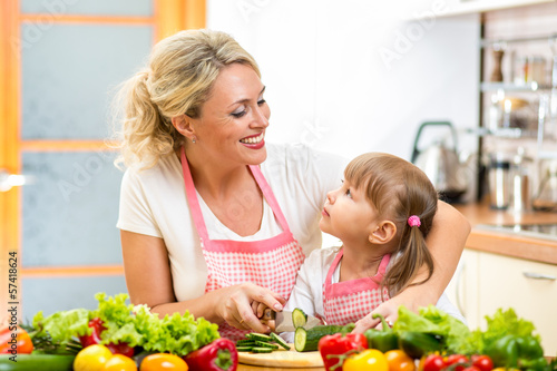 Photo: mom and kid preparing healthy food mom and kid preparing healthy food