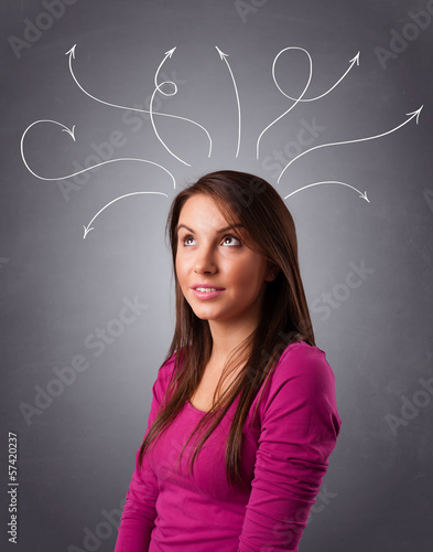 Photo: Young girl thinking with arrows overhead Young girl thinking with arrows overhead