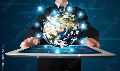 Photo: Businessman presenting 3d earth globe in tablet Businessman presenting 3d earth globe in tablet