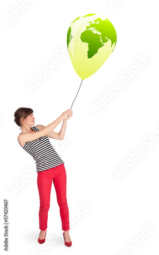 Photo: Happy lady holding a green globe balloon Happy lady holding a green globe balloon