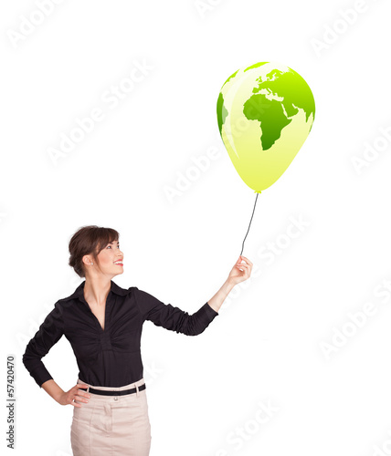 Photo: Happy lady holding a green globe balloon Happy lady holding a green globe balloon