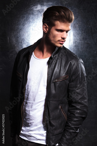 Photo: serious young fashion model in leather jacket serious young fashion model in leather jacket