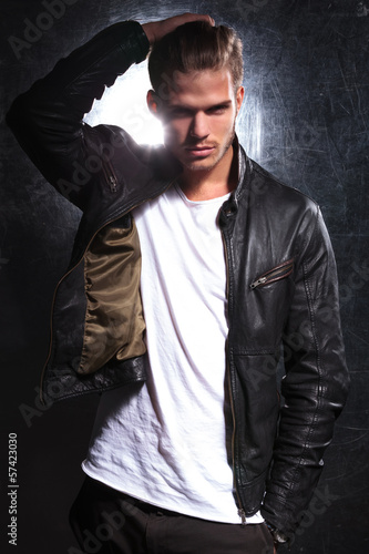 Photo: fashion model moving his hand through his long hair fashion model moving his hand through his long hair