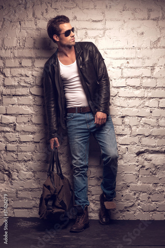 Photo: Sexy man with handbag. Sexy man with handbag.