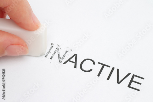 Photo: Hand erasing part of the inactive word close-up. Hand erasing part of the inactive word close-up.