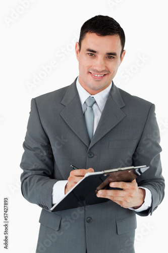 Photo: Smiling businessman taking notes Smiling businessman taking notes