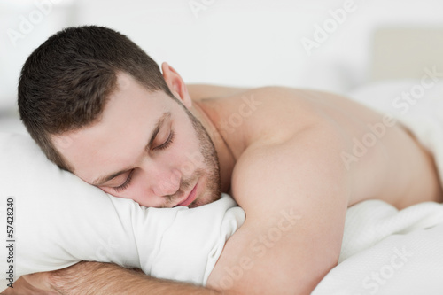 Photo: Man lying on his belly while sleeping Man lying on his belly while sleeping