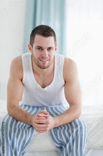Photo: Portrait of a quiet man sitting on his bed Portrait of a quiet man sitting on his bed