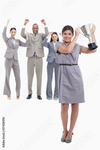 Photo: Woman holding a cup with happy co-workers Woman holding a cup with happy co-workers