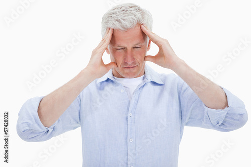 Photo: Exhausted man having a headache Exhausted man having a headache