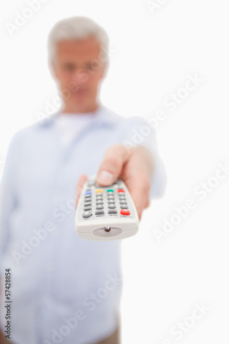 Photo: Portrait of a man switching of channel Portrait of a man switching of channel
