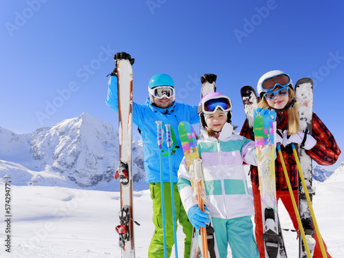 Photo: Ski, sun and fun - family enyoing winter vacation Ski, sun and fun - family enyoing winter vacation