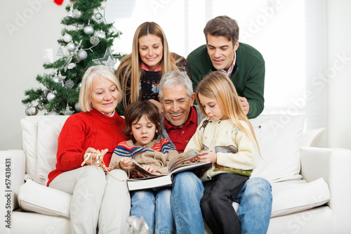 Photo: Family Reading Book Together In House Family Reading Book Together In House