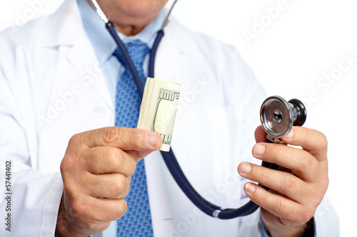 Photo: Hands of medical doctor with money. Hands of medical doctor with money.
