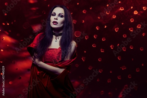 Photo: Beautiful vampire woman in red dress Beautiful vampire woman in red dress