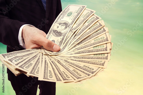 Photo: Business Man Displaying a Spread of Cash Business Man Displaying a Spread of Cash