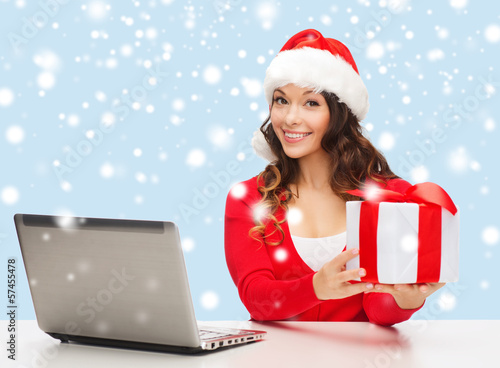 Photo: woman with gift box and laptop computer woman with gift box and laptop computer