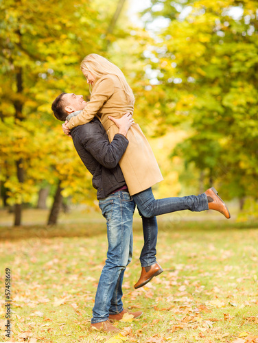 Photo: romantic couple playing in the autumn park romantic couple playing in the autumn park