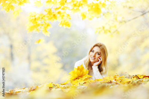 Photo: Woman laying in autumn park Woman laying in autumn park