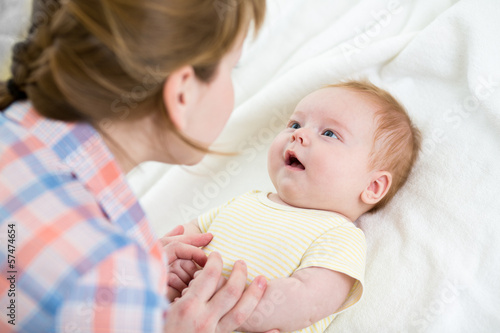 Photo: mom playing with her baby infant mom playing with her baby infant