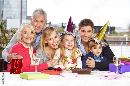 Photo: Siblings celebrating birthday together with family Siblings celebrating birthday together with family