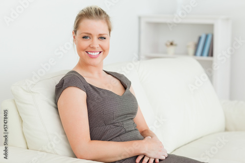 Photo: Woman sitting on a sofa Woman sitting on a sofa