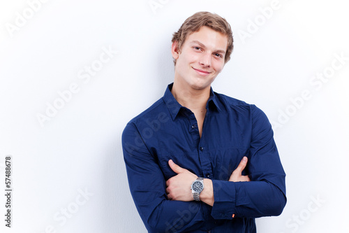 Photo: Portrait of a young handsome man wearing blue shirt isolated on Portrait of a young handsome man wearing blue shirt isolated on