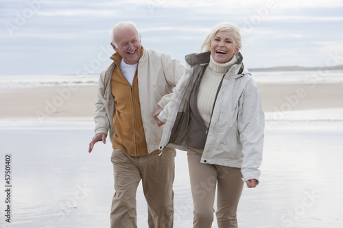 Photo: Romantic Mature Couple On Winter Beach Holiday Romantic Mature Couple On Winter Beach Holiday