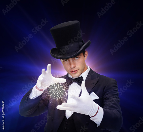 Photo: magician in top hat showing trick magician in top hat showing trick