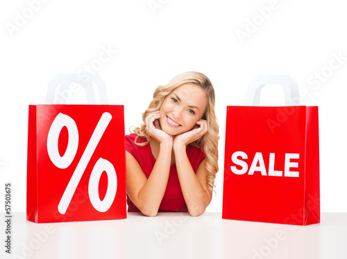 Photo: woman in red dress with shopping bags woman in red dress with shopping bags