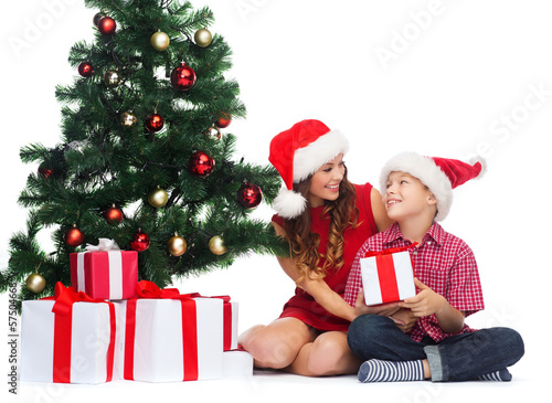 Photo: happy mother and child boy with gift boxes happy mother and child boy with gift boxes