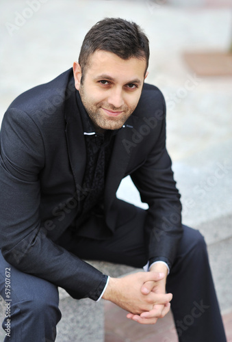 Photo: Handsome man looking confident in stylish suit Handsome man looking confident in stylish suit