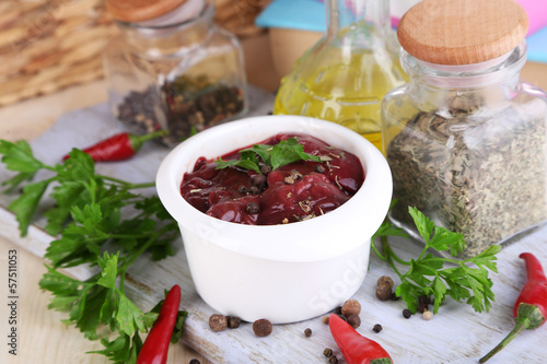 Photo: Raw liver in bowl with spices and condiments Raw liver in bowl with spices and condiments