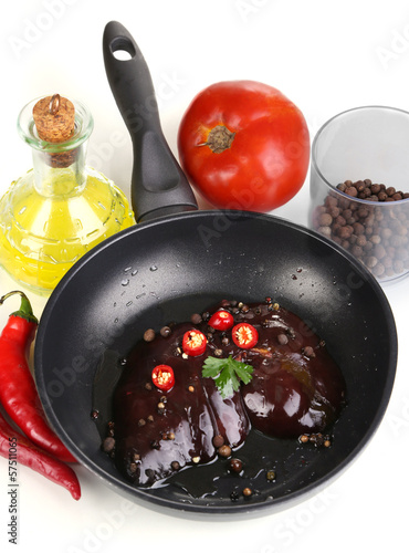 Photo: Raw liver in pan with spices and condiments isolated on white Raw liver in pan with spices and condiments isolated on white