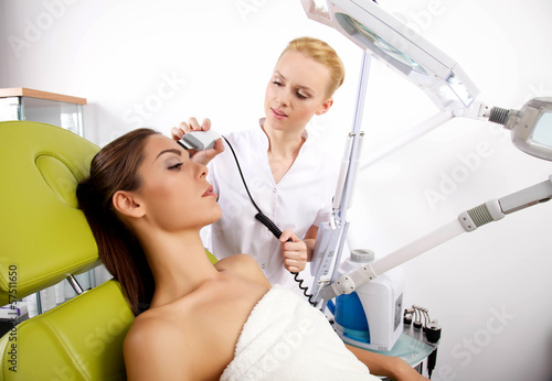 Photo: Young woman receiving laser therapy Young woman receiving laser therapy