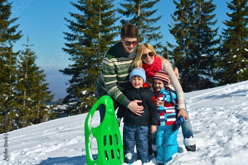 Photo: family having fun on fresh snow at winter family having fun on fresh snow at winter