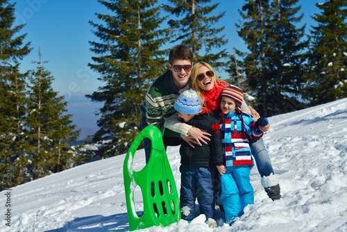 Photo: family having fun on fresh snow at winter family having fun on fresh snow at winter