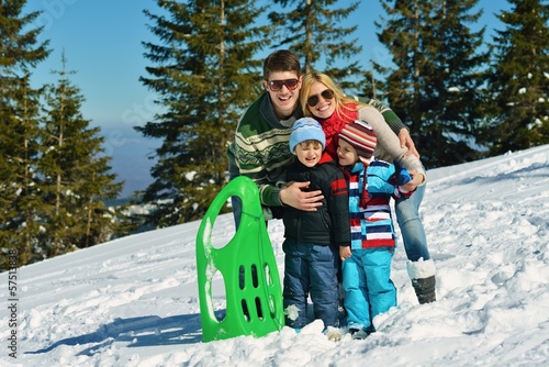 Photo: family having fun on fresh snow at winter family having fun on fresh snow at winter