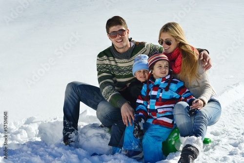 Photo: family having fun on fresh snow at winter family having fun on fresh snow at winter