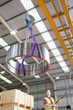 Photo: Supervisor examining machine part in bin on production line in distribution warehouse Supervisor examining machine part in bin on production line in distribution warehouse
