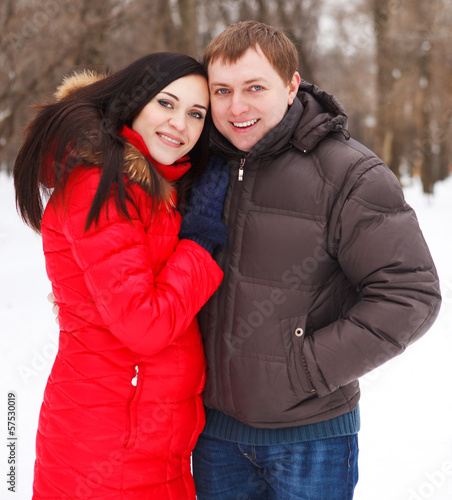 Photo: Happy young couple in the winter park Happy young couple in the winter park