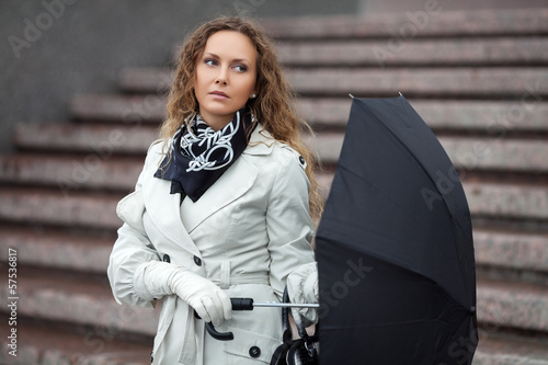 Photo: Sad beautiful woman with umbrella Sad beautiful woman with umbrella