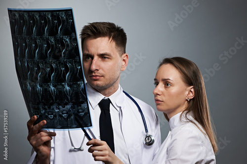 Photo: Medical doctors team with MRI spinal scan Medical doctors team with MRI spinal scan