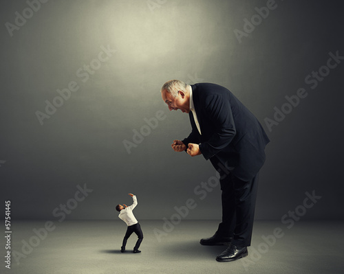Photo: boss screaming at small startled worker boss screaming at small startled worker
