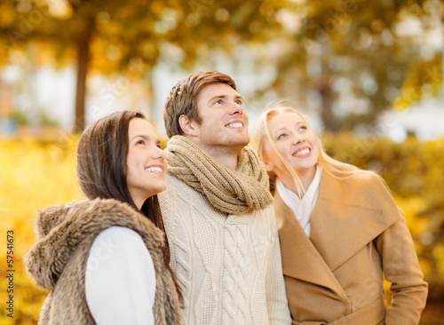 Photo: group of friends having fun in autumn park group of friends having fun in autumn park